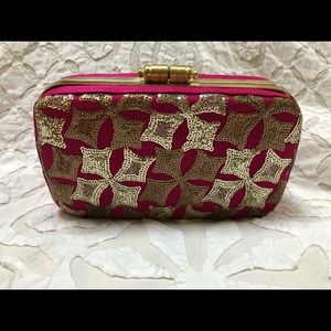 Fuchsia clutch with sequin and embroidery detail.